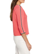 Coral ribbed sweater, three-quarter sleeves.  Black and white trim detail along shoulders and sleeves.