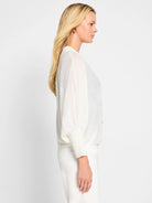 Off-white ramie cardigan,  three-quarter sleeves, slightly puffed.  Button front.