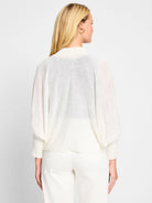 Off-white ramie cardigan,  loose fit, 3/4 sleeves with ribbed cuffs, shown from the back.
