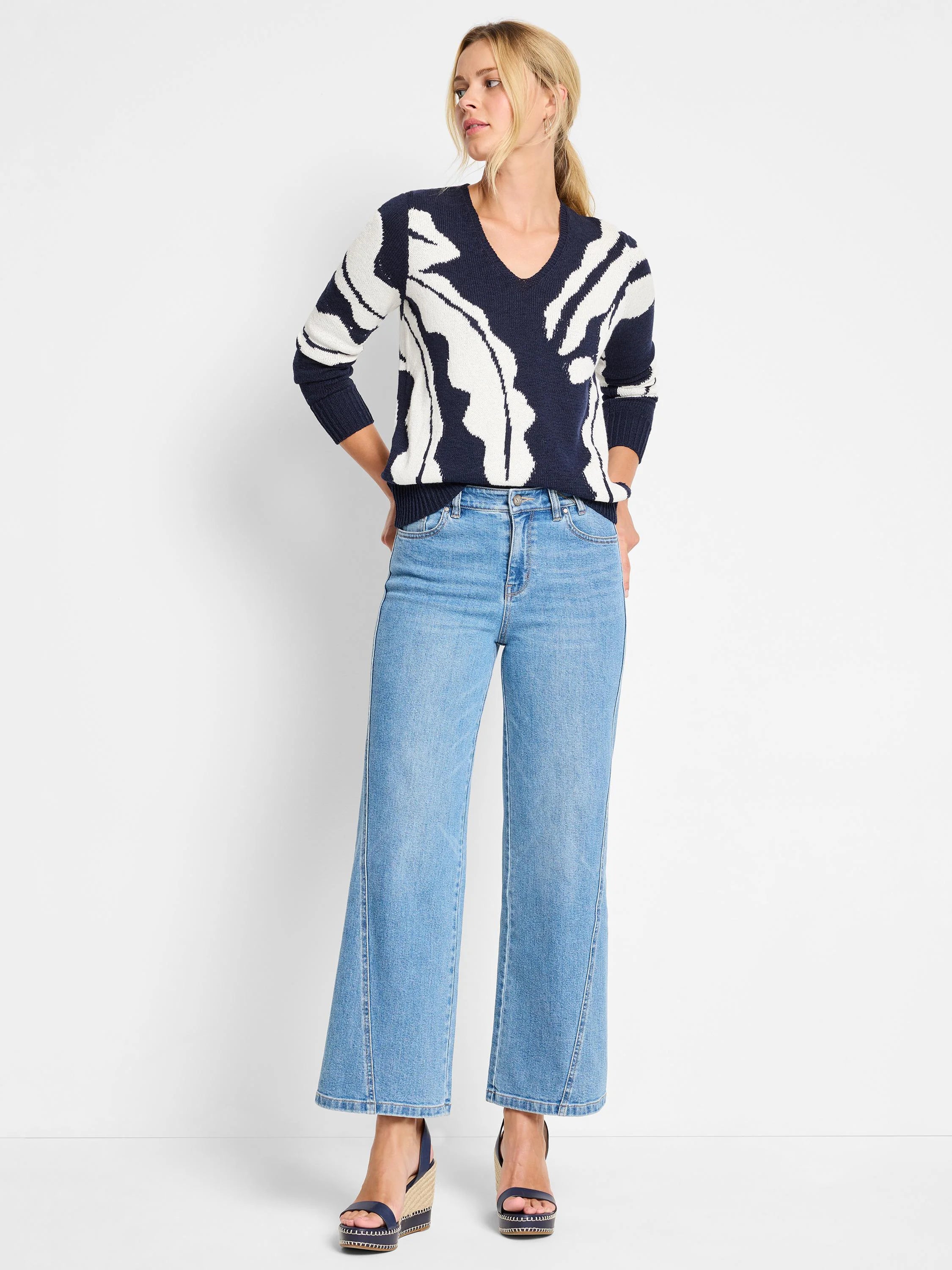 Navy blue sweater with an off-white abstract print.  Long sleeves, V-neck.