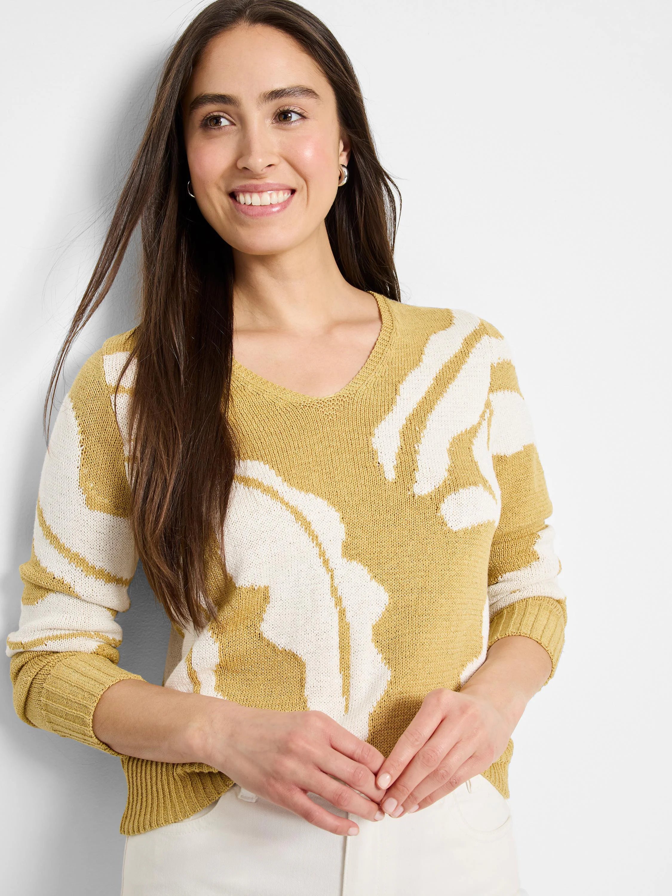 Mustard yellow knit sweater with off-white abstract pattern.  V-neck. Long sleeves.