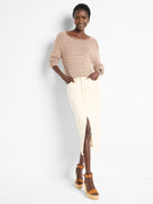 Beige cotton sweater with thin brown stripes, seamed detailing at shoulders.