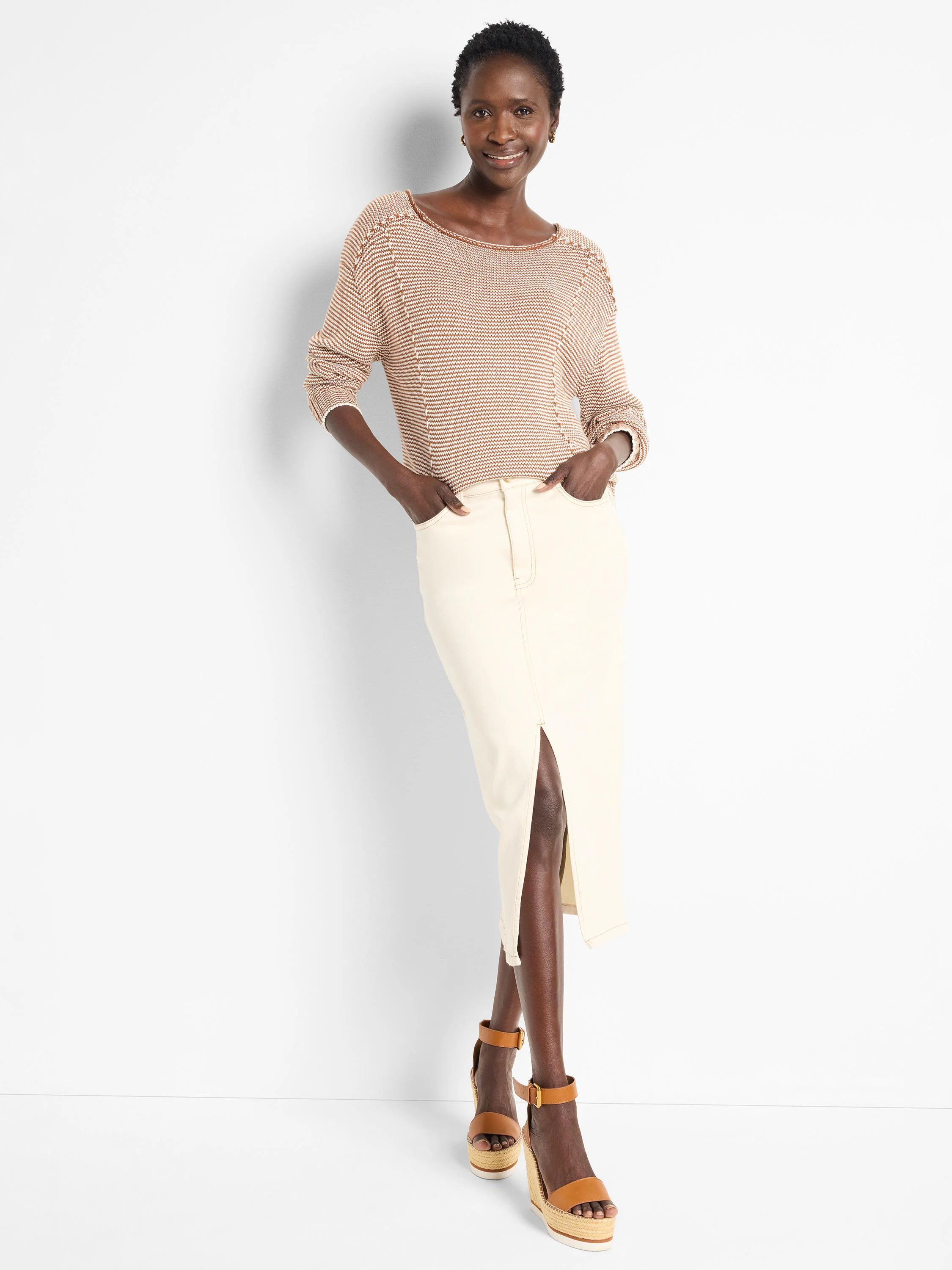 Beige cotton sweater with thin brown stripes, seamed detailing at shoulders.