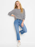 Black and white textured cotton sweater; long sleeves,  round neckline.