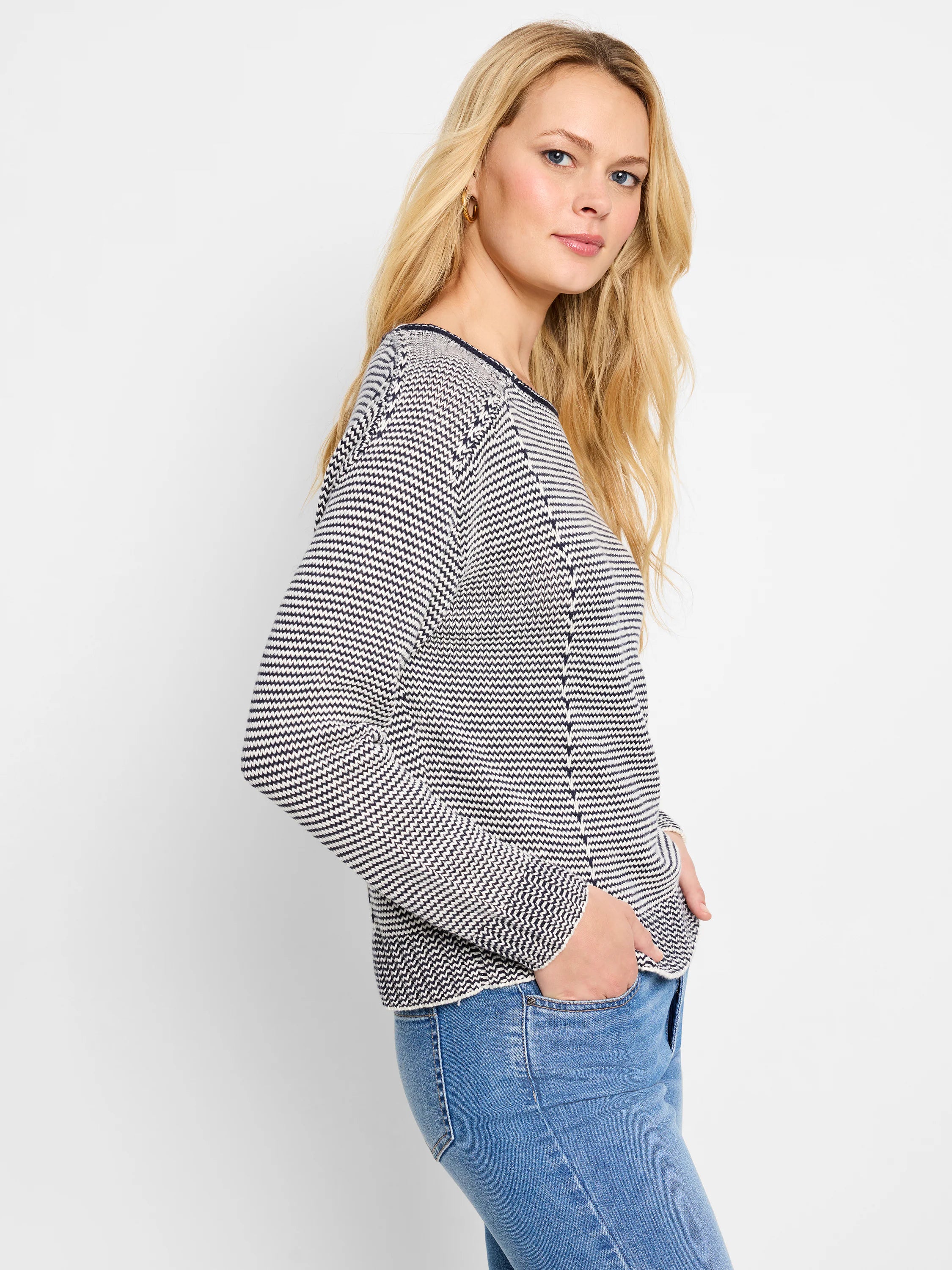 Cream and navy striped cotton sweater. Long sleeves, seamed detailing at shoulders and sides.  Relaxed fit.