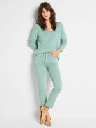 Mint green V-neck sweater with a textured knit.