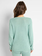Mint green cotton cord knit sweater, back view. Round neck, long sleeves, ribbed cuffs & hem.