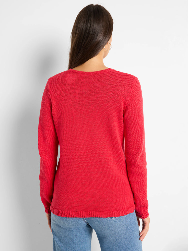 Back view of a person wearing a red knit sweater with ribbed cuffs and hem, over blue jeans.