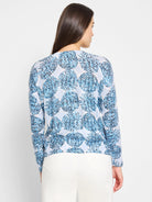 Light blue sweater with a dark blue and white patterned design of small, clustered circles.  Long sleeves.