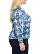 Long-sleeve, light blue sweater with a blue and white patterned design.  The pattern consists of small, dark blue dots...