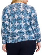 Light blue sweater with a pattern of dark blue, small, clustered circles.  Long sleeves.