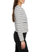White and navy tweed sweater jacket with crosshatch pattern, navy trim, and gold buttons.