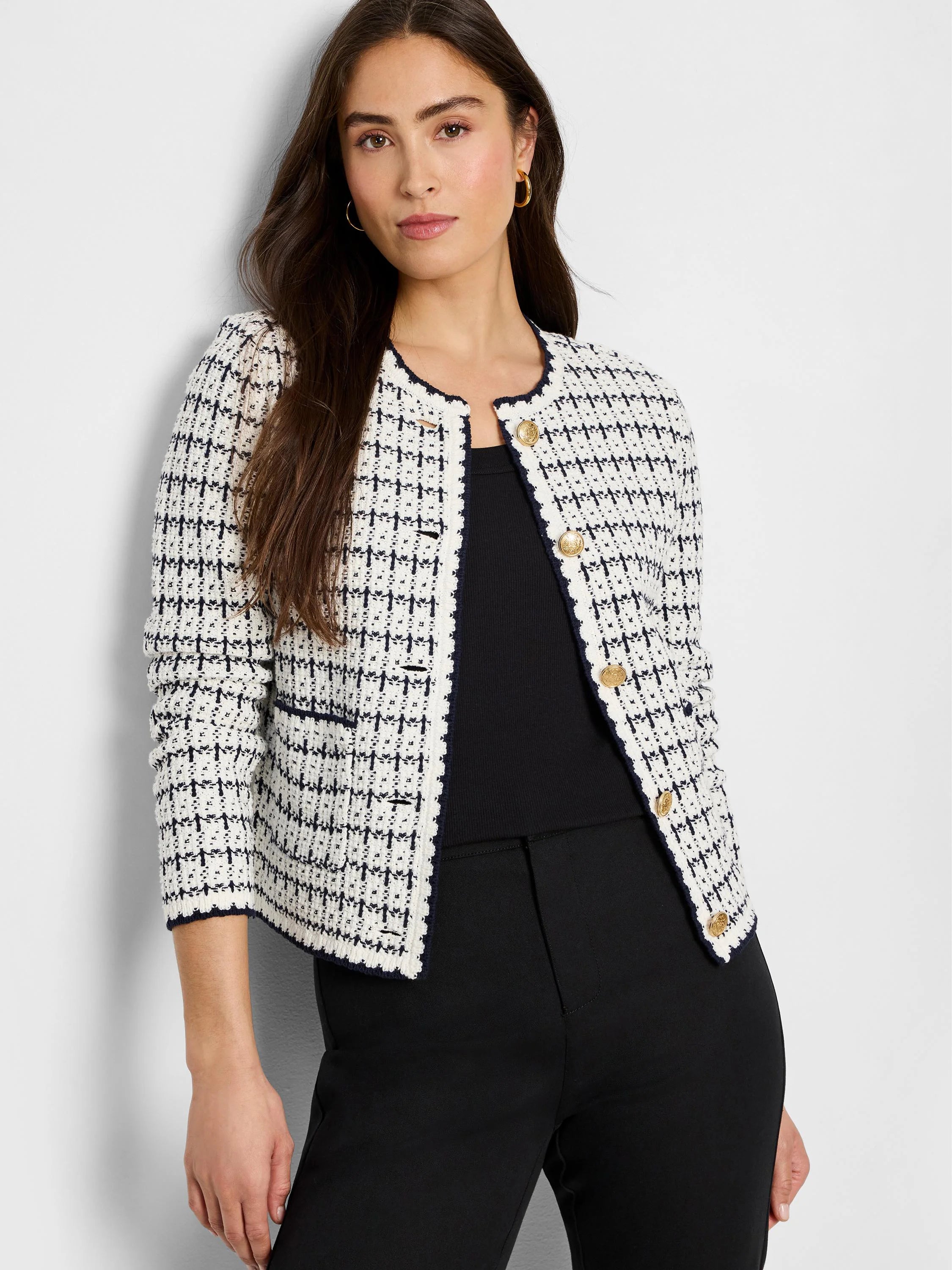 Cream & navy knit jacket with fine grid pattern, collarless, dark trim, and gold buttons.
