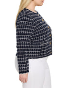 Navy and white tweed sweater jacket with a grid pattern, gold buttons, round neck, and white trim.
