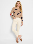 Beige sweater with dark blue and red hearts.