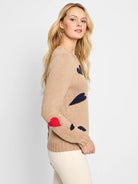 Beige sweater with navy and red heart accents.