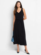 Black midi dress, sleeveless, V-neck, belted waist.