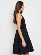 Black sleeveless ribbed knit top and pleated A-line skirt midi dress.