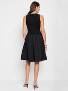 Black sleeveless ribbed knit top and pleated A-line skirt midi dress.