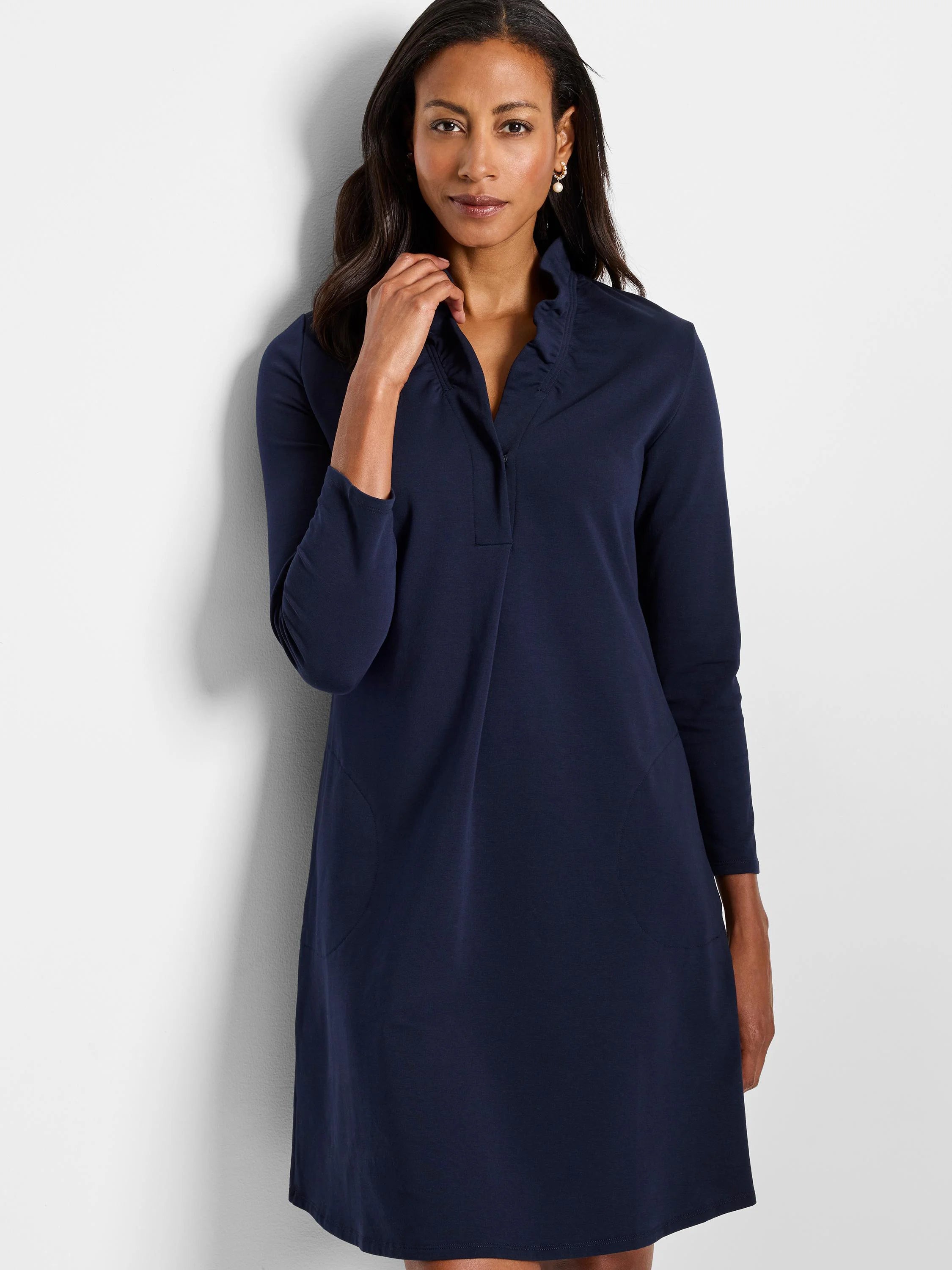 Navy blue knit dress, 3/4 sleeves, ruffled collar, A-line silhouette, and angled pockets.