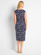 Here's alt text under 125 characters:

"Sleeveless midi dress, navy blue and off-white abstract print.  Back view.