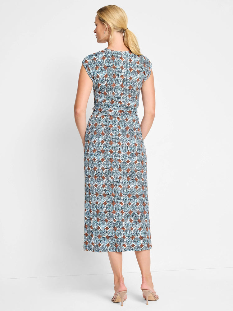Mid-length dress, teal and brown circular pattern, short sleeves, belted waist.