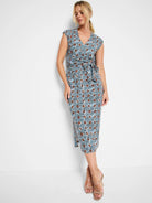 Mid-length sleeveless dress; blue, brown, & white geometric print; V-neck; belted waist.