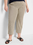 Beige wide-leg jeans with thin dark vertical stripes, cropped length, and front slash pockets.