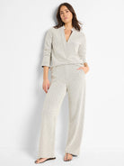 Off-white wide-leg pants with a subtle dark-grey swirl knit pattern.