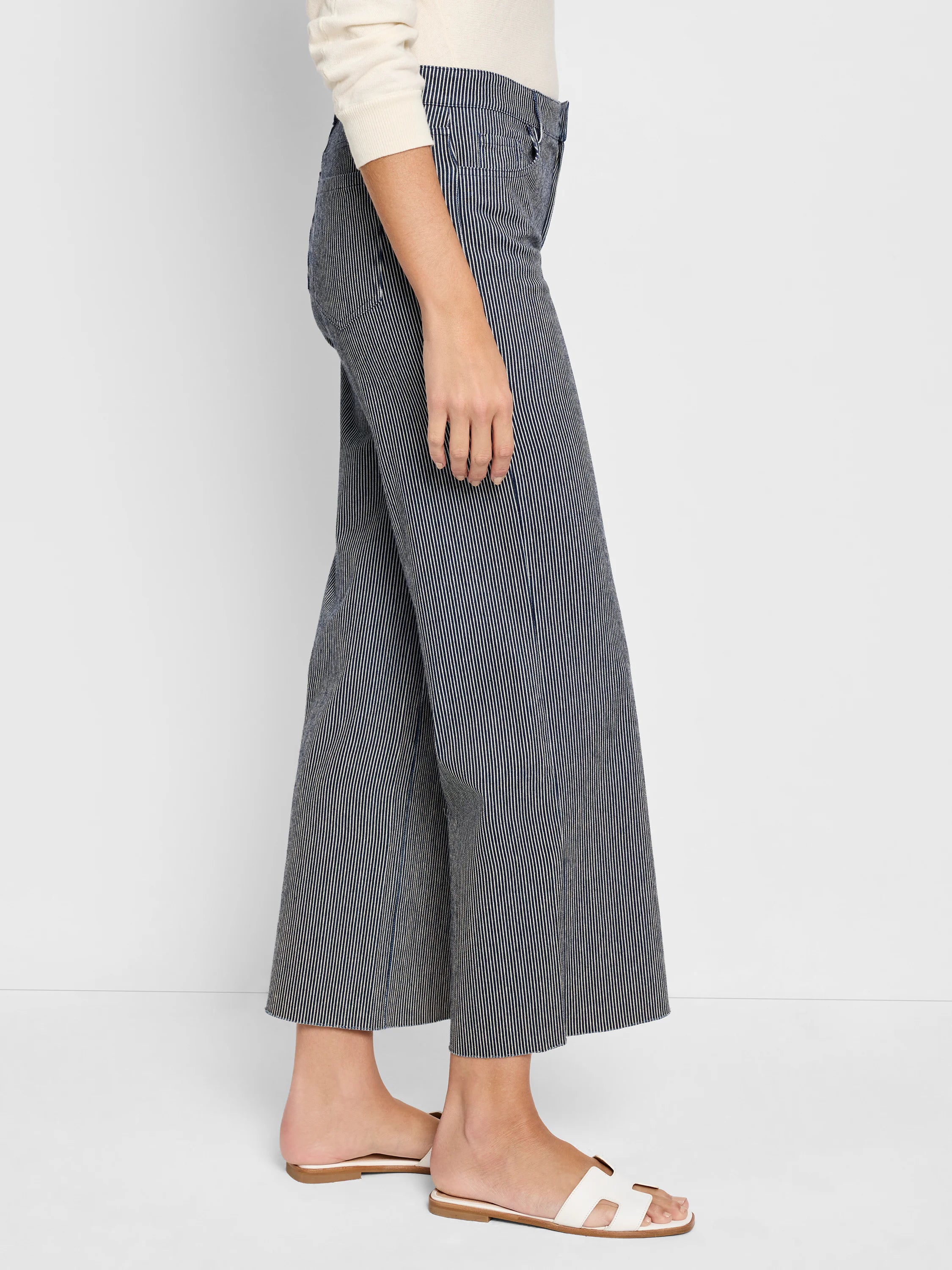 Wide-leg jeans; dark blue and white vertical stripes; raw hem.