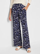 Wide-leg pants; off-white background with navy blue abstract pebble print.