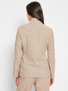 Beige linen-cotton blazer, long sleeves, collared.  Textured fabric. Shown from the back.