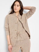 Beige linen-cotton blazer with gold buttons, mandarin collar, and drawstring waist.  Long sleeves.
