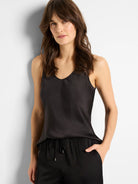 Black scoop-neck tank top with thin straps.  Woven fabric with subtle sheen.