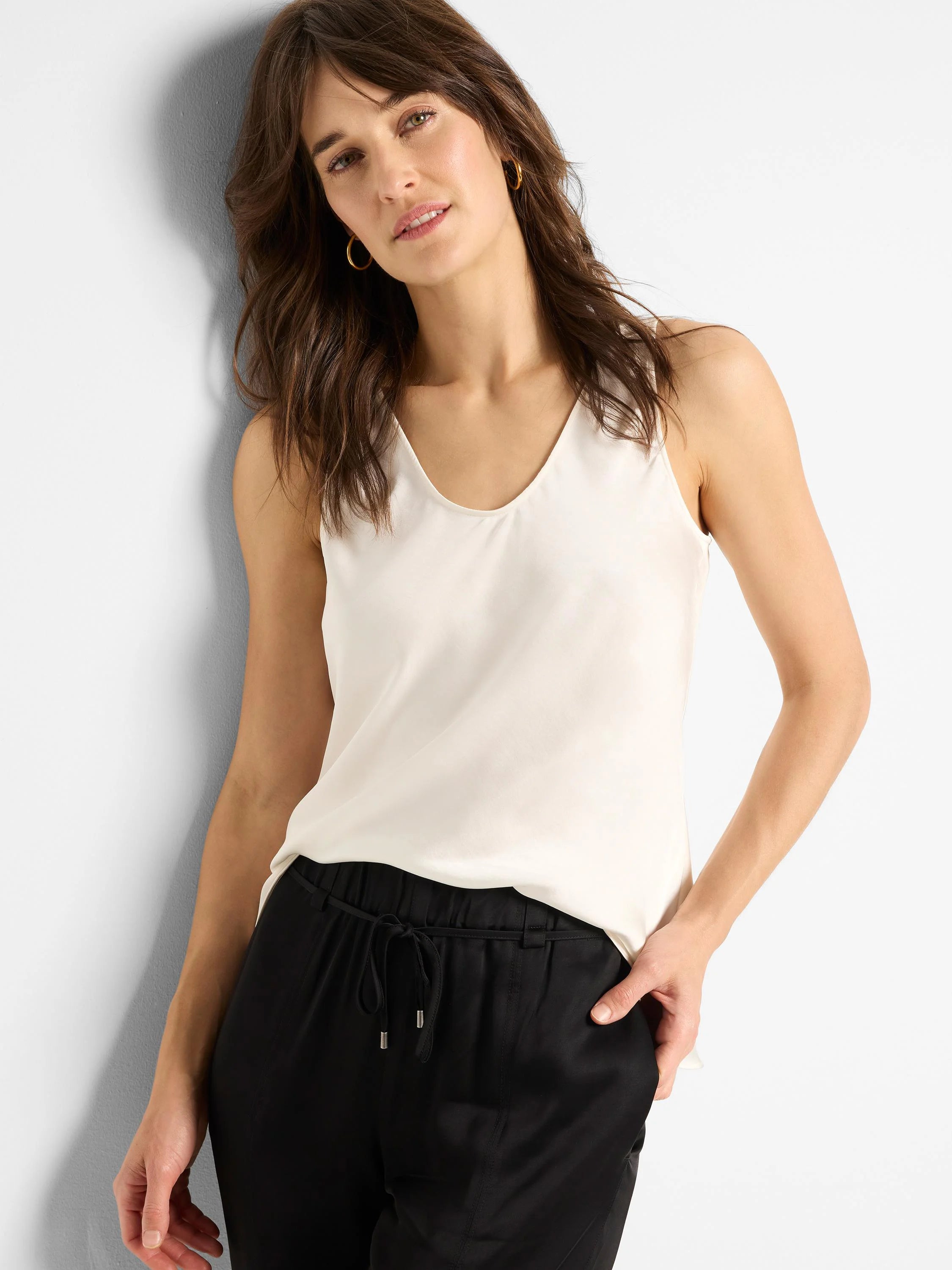 Off-white scoop-neck sleeveless woven top.