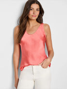 Coral sleeveless scoop-neck satin top.