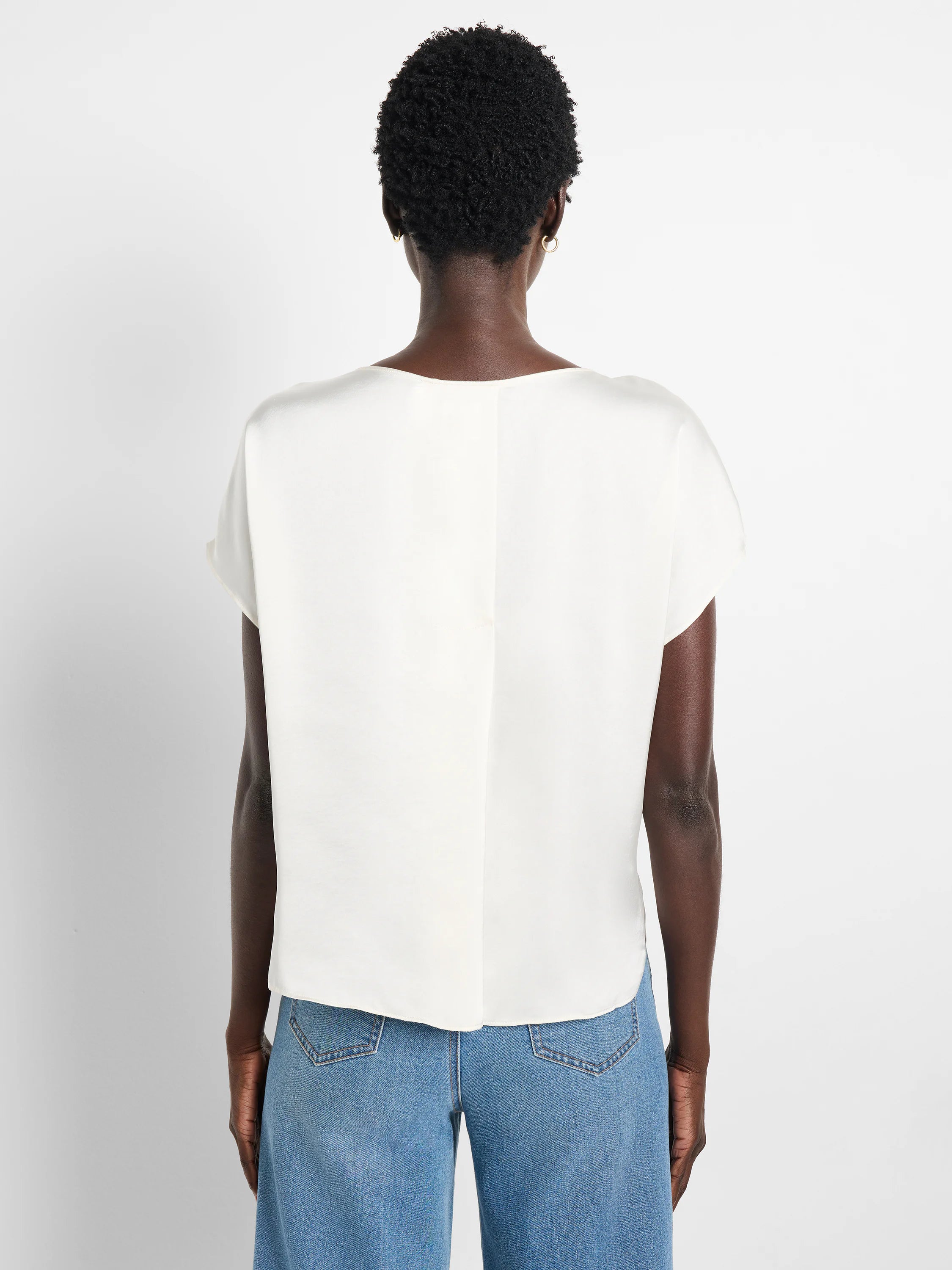 Off-white woven top, short sleeves, boat neck.  Rear view.