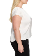 Cream woven tee with subtle sheen, round neck, short sleeves, and a relaxed fit with a curved hem.