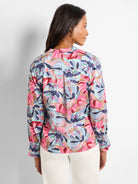 Pink, blue, and purple abstract floral print woven top with long sleeves and button cuffs.  Back view shown.