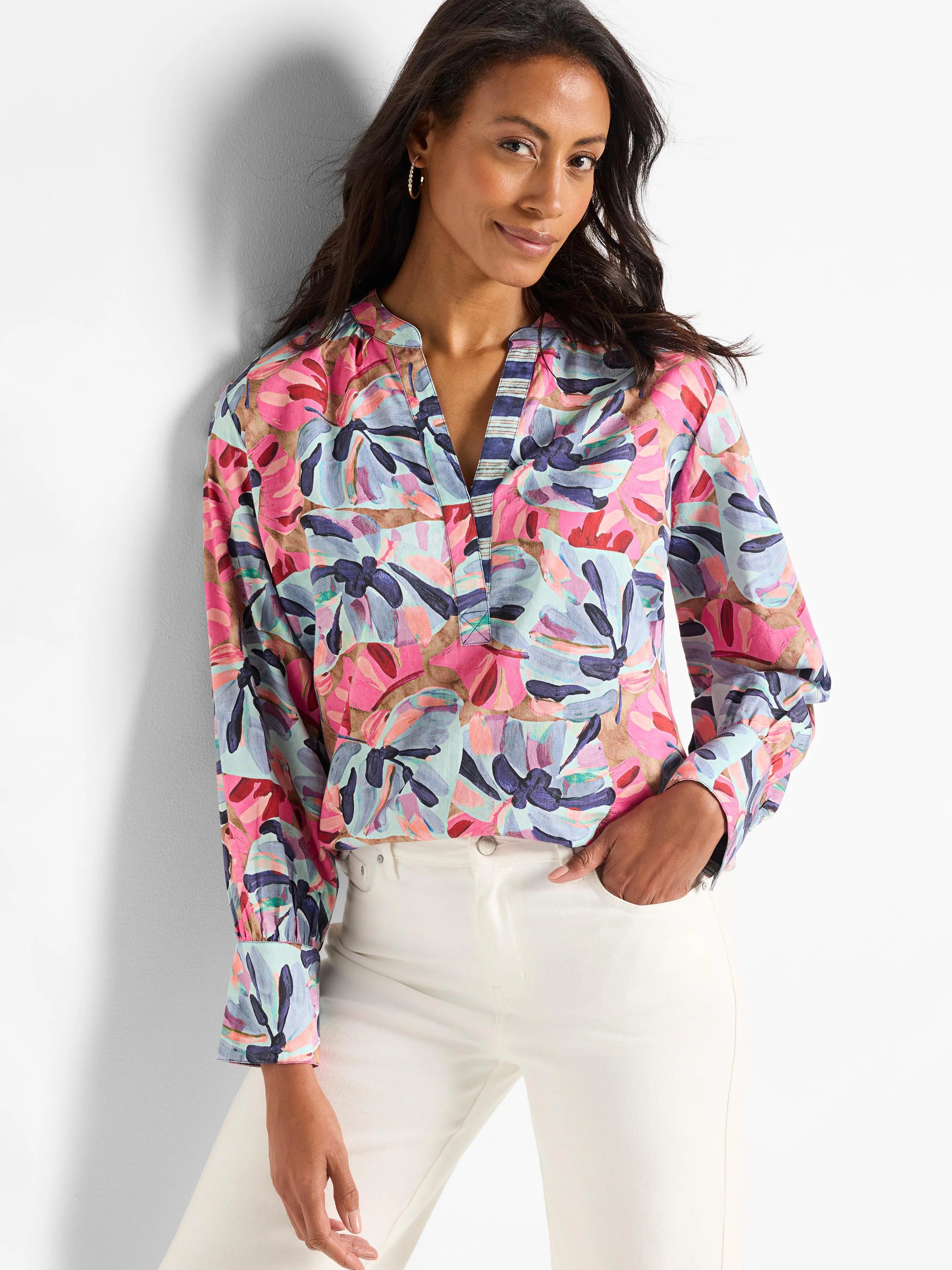 Pink, teal, blue, and brown abstract floral print woven top.  Long sleeves, v-neck with striped detail.