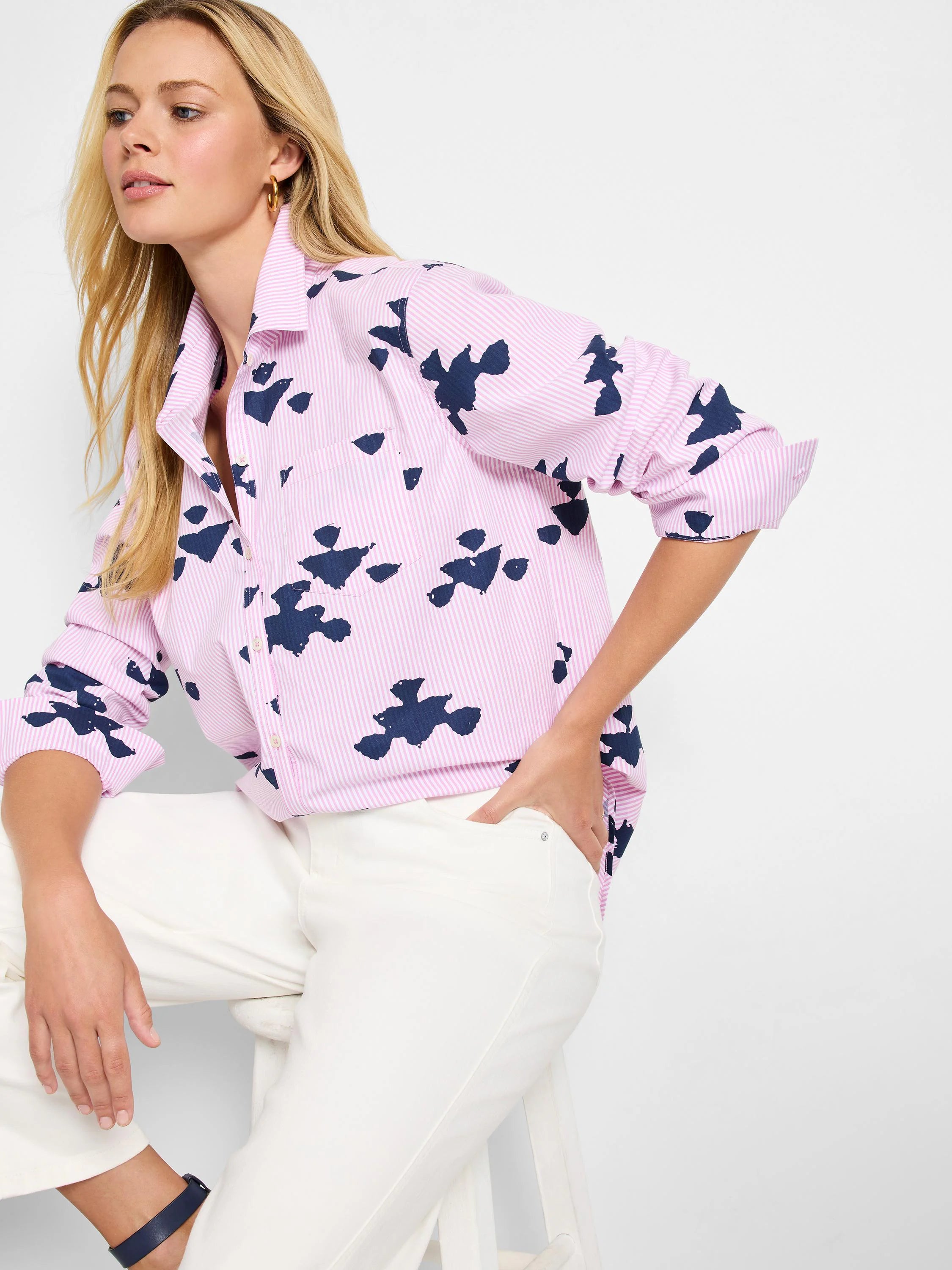 Pink shirt with thin white stripes and dark blue stamped abstract shapes.  Long sleeves, button front.