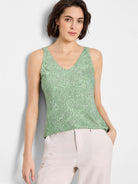 Light green sleeveless v-neck tank top with a white and black speckled pattern.