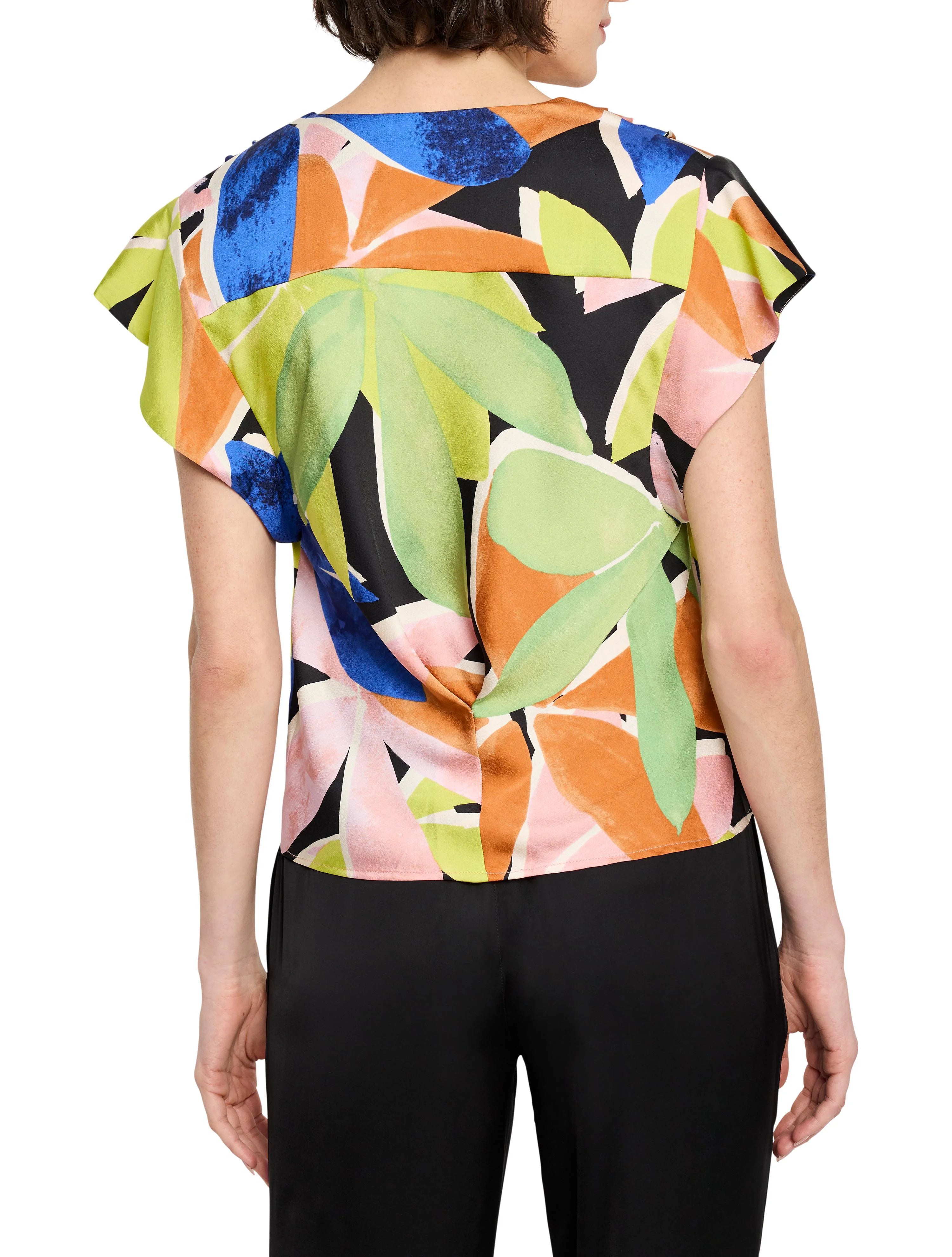 Black background, abstract leaf print in teal, orange, pink & lime green. Flutter sleeves.  Short sleeves.