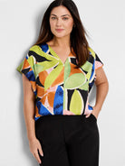 Abstract leaf print woven top.  Lime green, orange, pink, blue, and black on black background. V-neck, short sleeves.