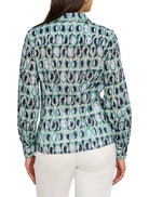 Green, blue, and white patterned shirt.  Repeating ring design. Long sleeves, collared.