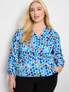 Mosaic Sofia Top: V-neck, 3/4 sleeves. Blue, brown, and white geometric print on a satin-like fabric.