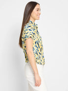 Yellow short-sleeved shirt with blue abstract print.  Collared, button-front.