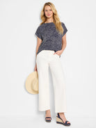 Navy blue short-sleeve top with a white abstract print.