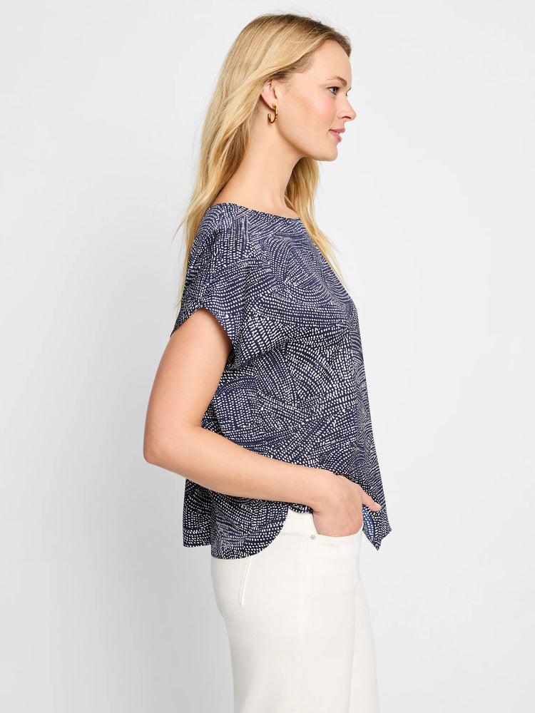 Navy blue short-sleeved boatneck top with a white swirling dot pattern.