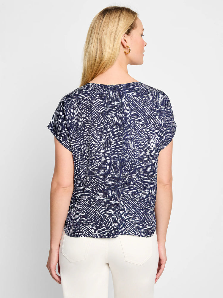 Navy blue short-sleeved top with a white abstract dot pattern.  The back view shows a relaxed fit.
